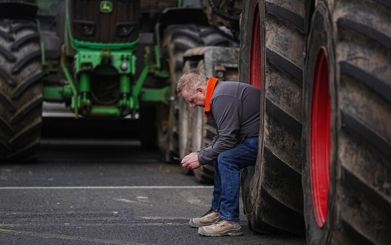 A man sits in a tractor wheel as vehicles are parked on O'Connell Street in Dublin as protesters take part in a National Fuel Protest against rising fuel prices. Picture: Brian Lawless/PA Wire