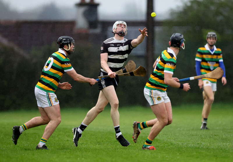 Midleton's Evan McGrath brings the ball out of defence, shadowed by Glen Rovers paid Gearóid Mulcahy and Jake Brosnan. Picture: Jim Coughlan