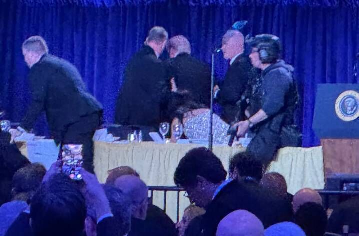 US Secret Service agents escorted the president and first lady from the room. Picture: Mark Schiefelbein/AP