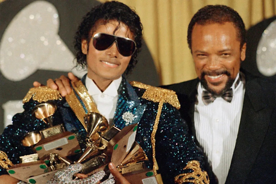 Michael Jackson, with producer Quincy Jones, after winning a record-breaking eight Grammys in one night in 1984 (AP)