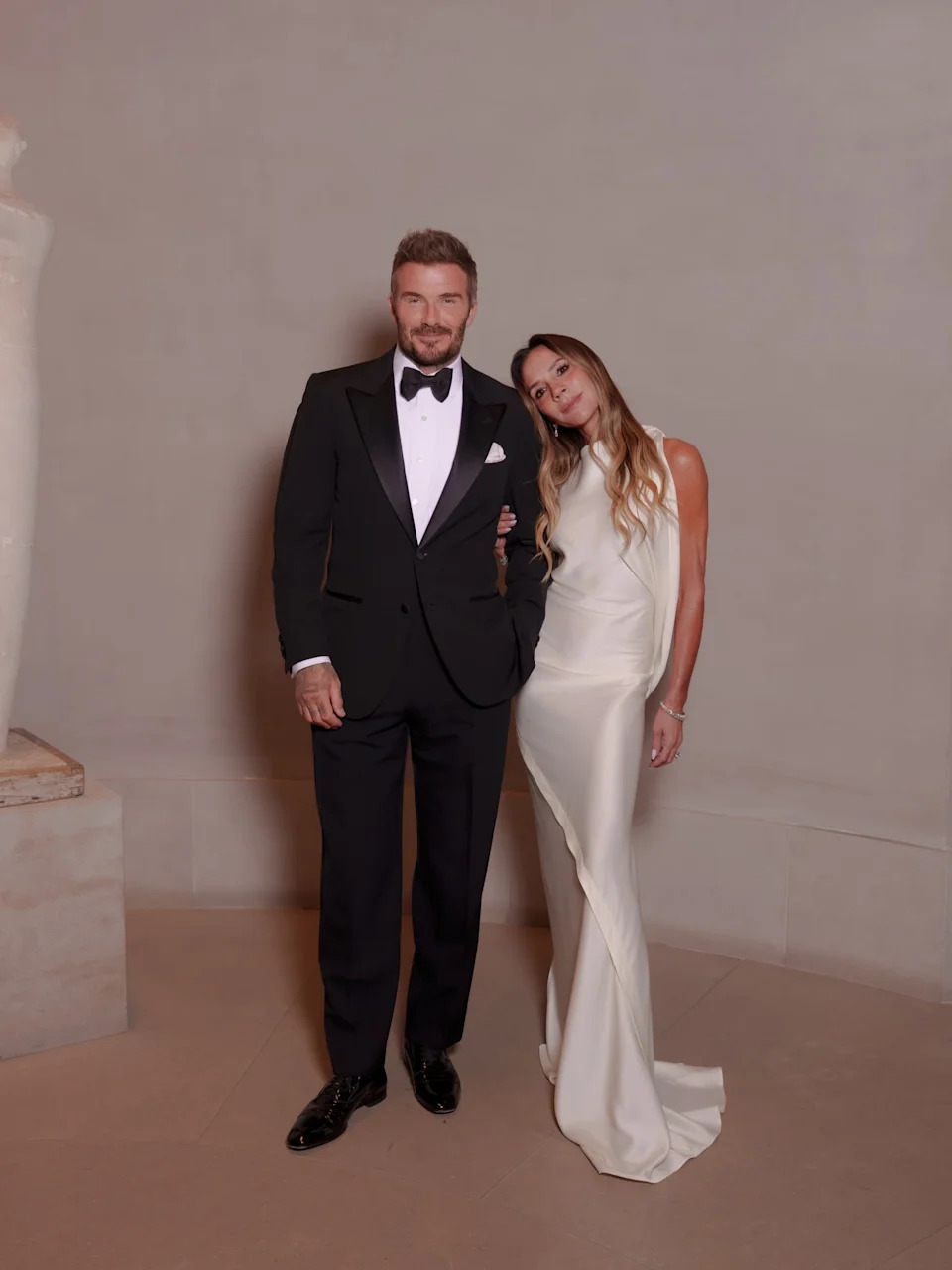 The fashion designer tired to hold back her smile while the athlete smiled and laughed.