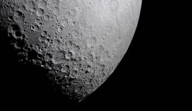 Part of the Moon stands out against the blackness of space. Its surface is marked with many craters of different sizes. The craters are mostly on the left and bottom. The upper right portion of the Moon's surface is much smoother.