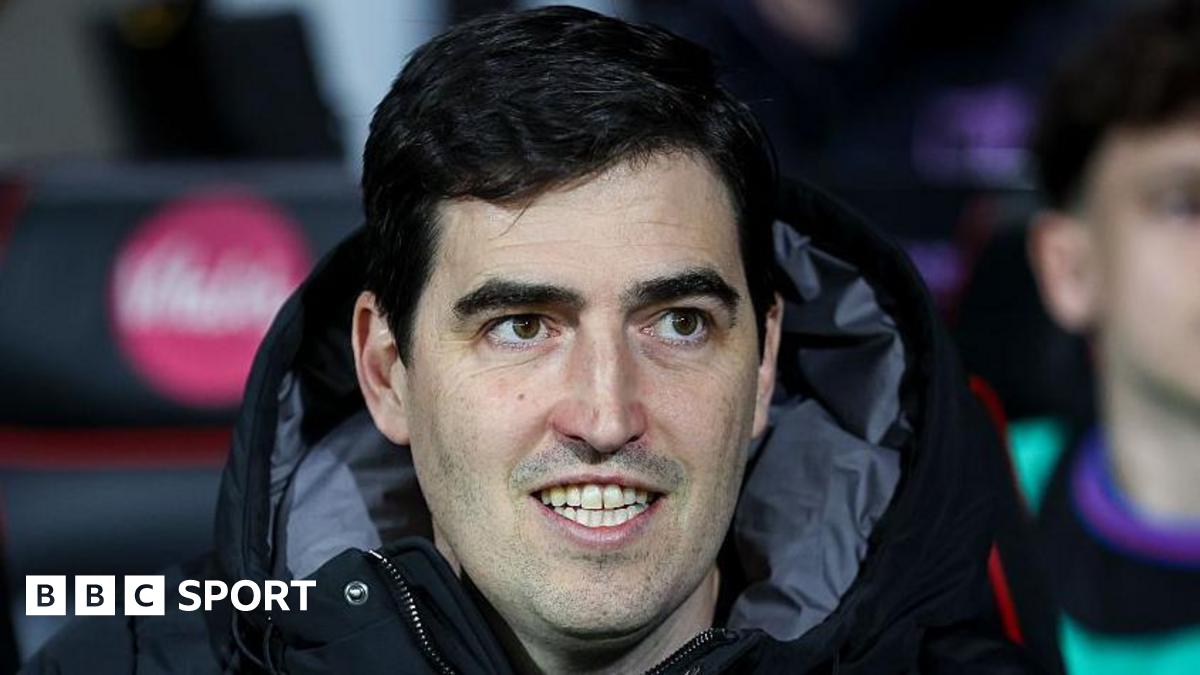 Bournemouth manager Andoni Iraola smiles as he watches a match