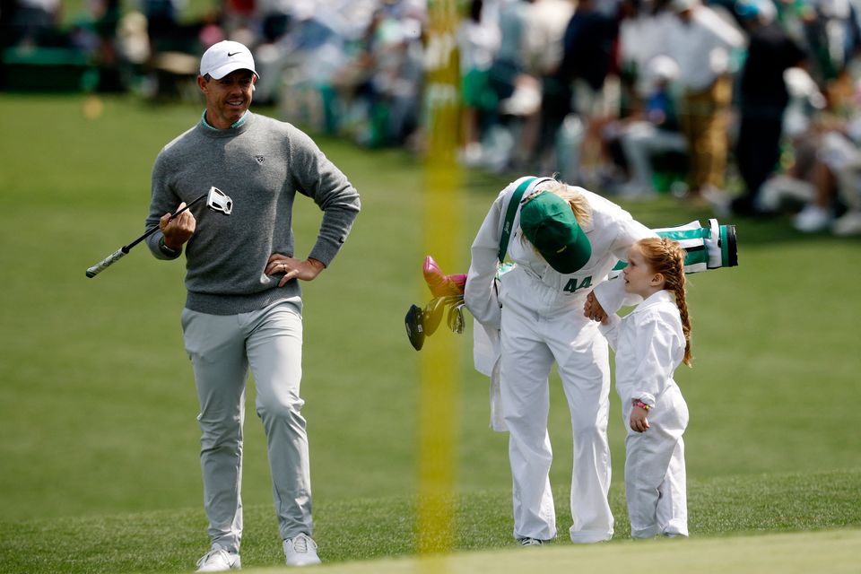 Golf - The Masters - Augusta National Golf Club, Augusta, Georgia, U.S. - April 8, 2026
Northern Ireland's Rory McIlroy with Ireland's Shane Lowry's wife Wendy Lowry and daughter Iris Lowry on the green of the 2nd hole during the par 3 contest REUTERS/Brian Snyder
