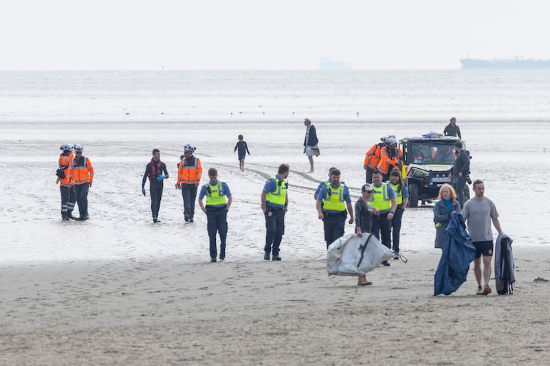 Personnel from the Irish Coast Guard and volunteers from the Irish Whale and Dolphin Group on Sandymount Beach ahead of an attempt to rescue a stranded dolphin on Sunday morning. Photograph: Tom Honan/The Irish Times