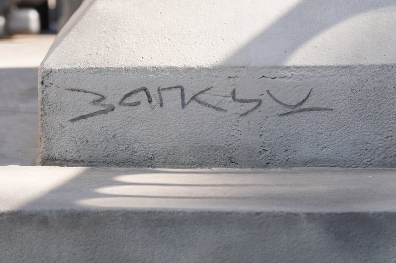 'Banksy' appears at the based of the new statue. Photograph: Lucy North/PA Wire