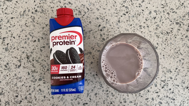 Cookies & Cream bottle with a glass cup