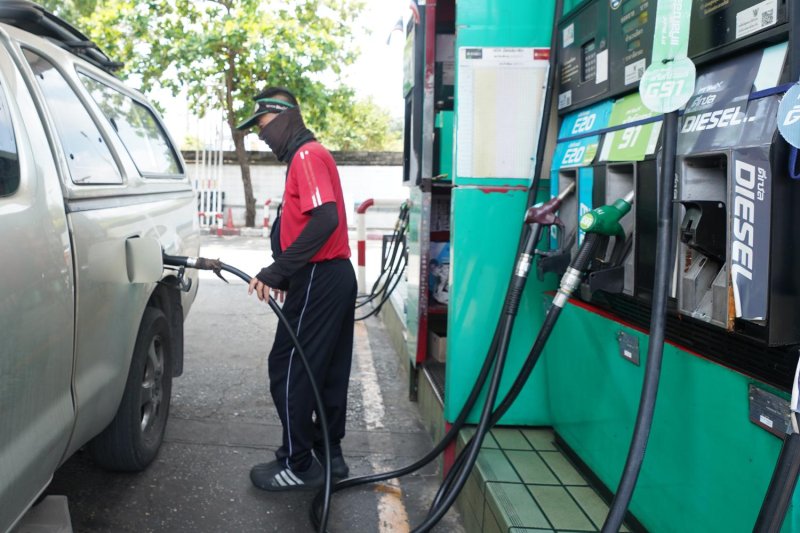 A petrol pump attendant fills a motorist's tank at a filling station in Bangkok. As a result of the current energy crisis, GDP growth this year may fall short of the 2% target projected by the National Economic and Social Development Council.