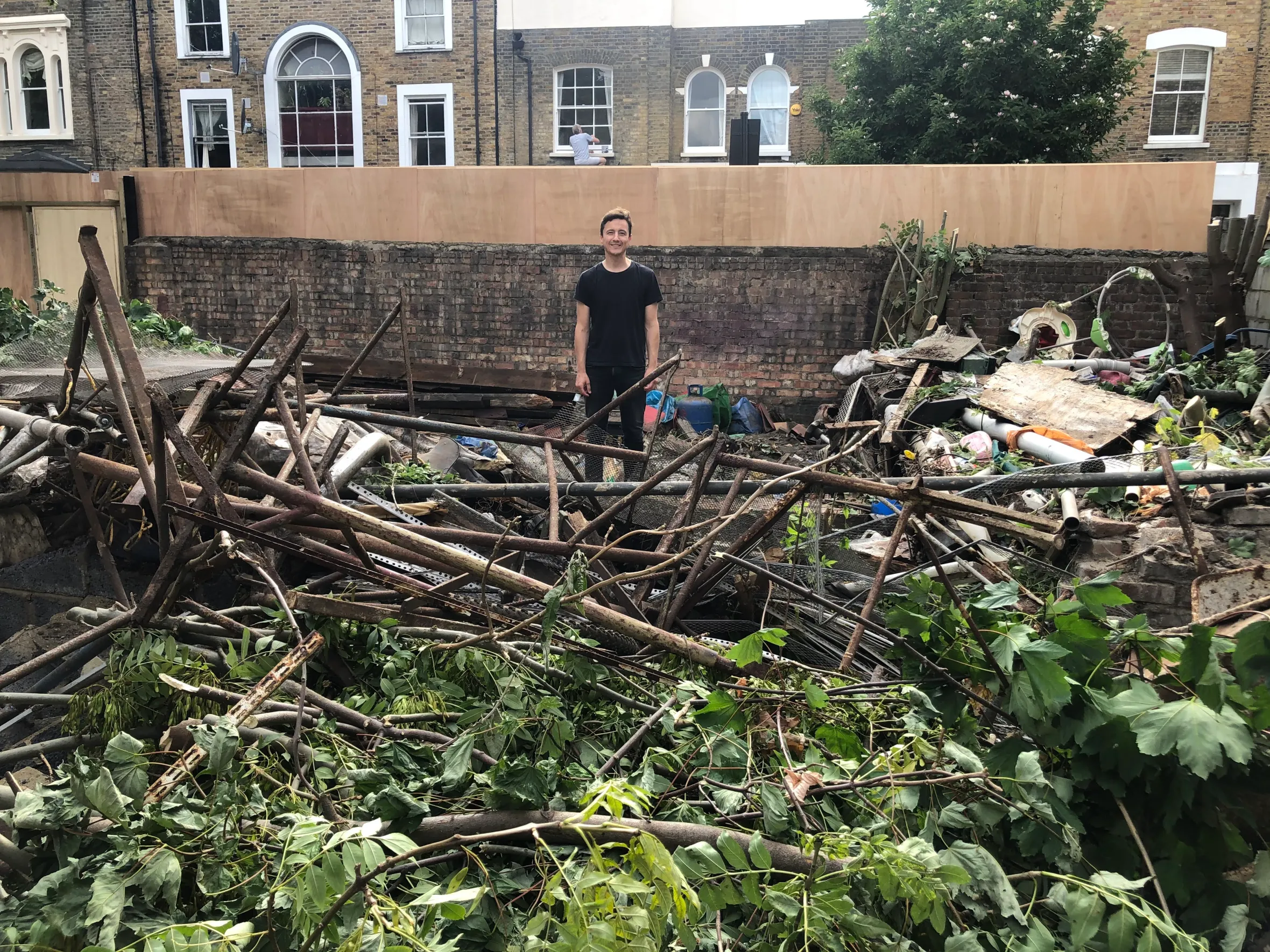 Man stands in front of a construction site that is undergoing work for Greenview House.