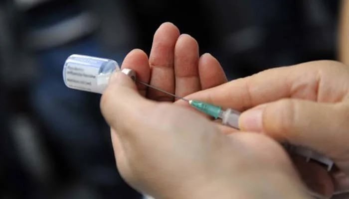 A health worker fills a disposable injection with a medicine.— AFP/File