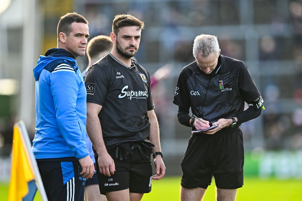Referee Fergal Kelly takes the names of Dublin manager Ger Brennan and to Galway strength and conditioning coach Cian Breathnach McGinn before sending them both off before the start of the second half during their Allianz FL Division 1 tie at Pearse Stadium in Salthill. Photo: Piaras Ó Mídheach/Sportsfile