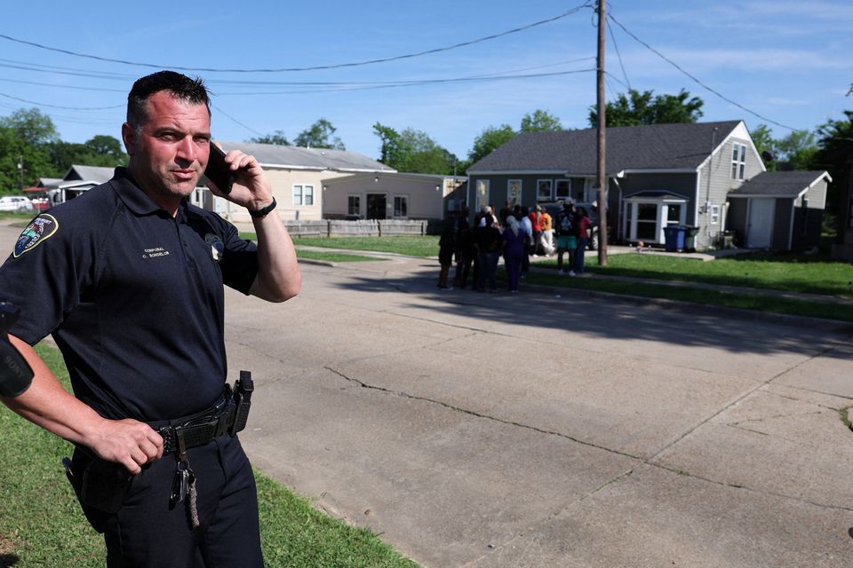 Shreveport Police Department public affairs officer Christopher Bordelon uses a cellphone after children, with ages ranging from 1 to 14, were killed in a mass shooting incident described as domestic violence, in Shreveport, Louisiana, U.S. April 19, 2026.  REUTERS/Kevin Bartram