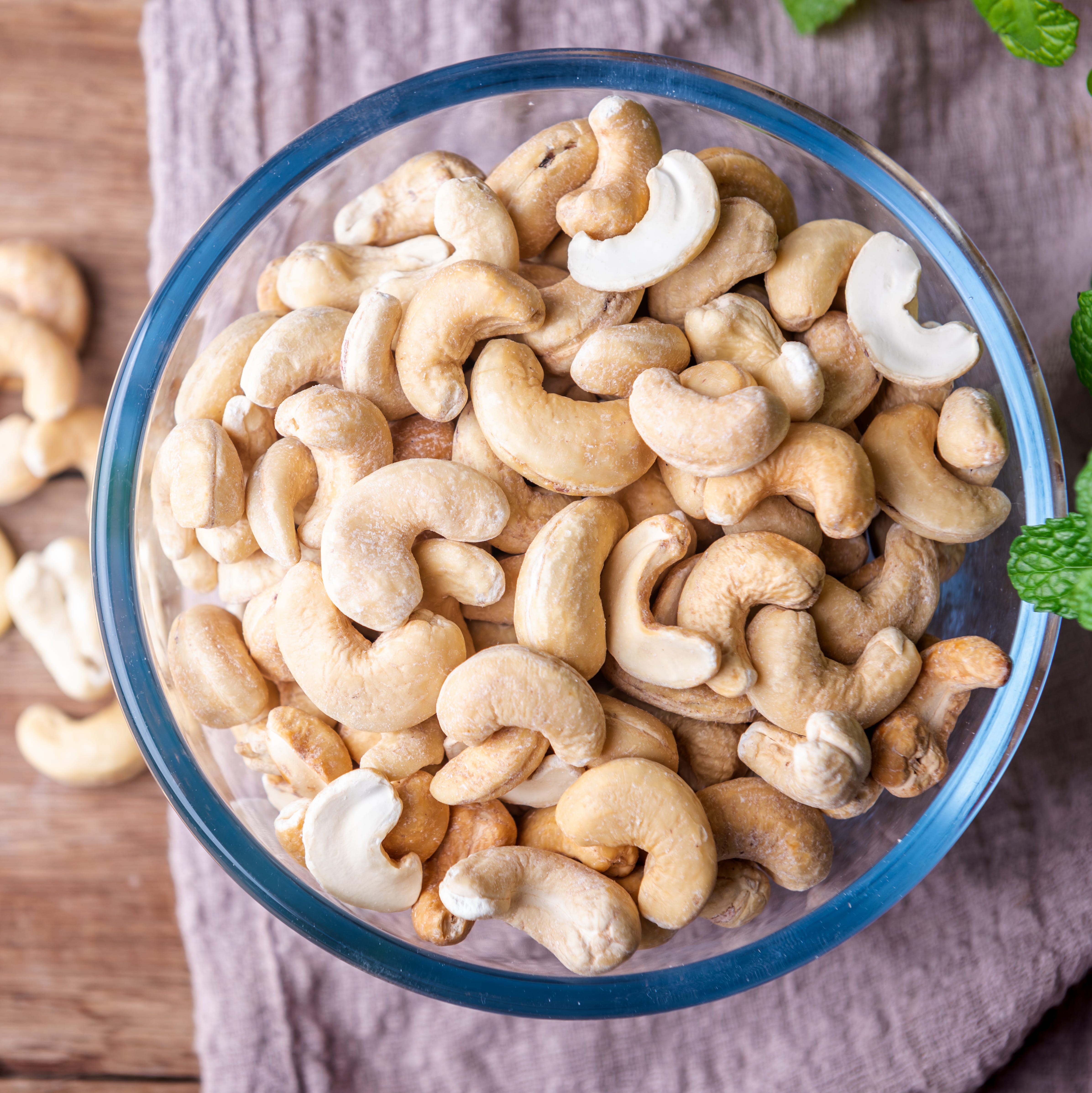 cashew nuts on wooden background, top view
