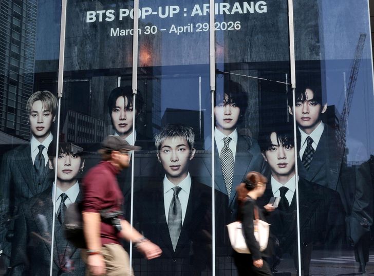 Passerby walks past a pop-up store of K-pop boy band BTS ahead of the band's upcoming BTS World Tour 'ARIRANG' concert, at Tokyo's Shibuya district / Reuters-Yonhap