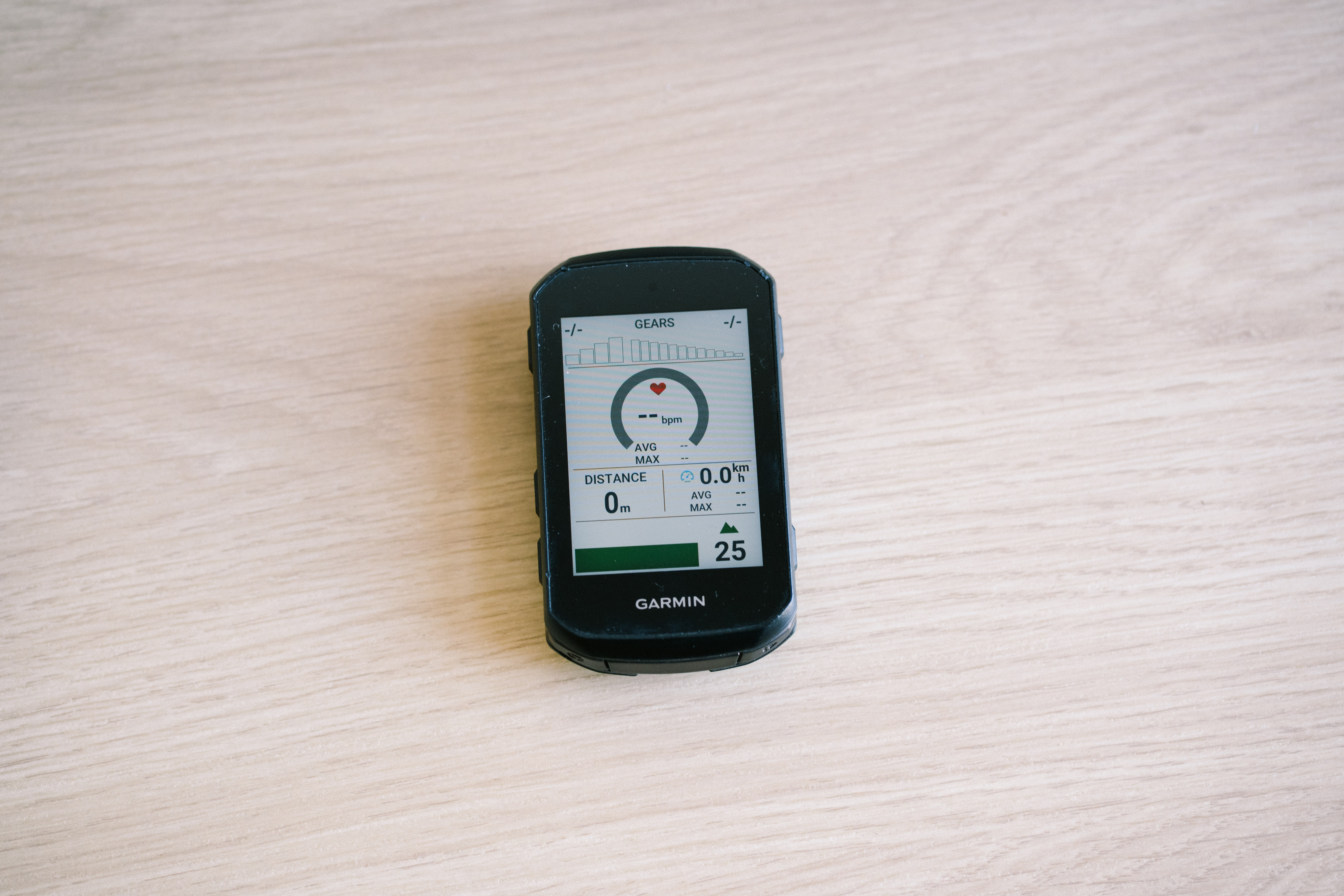Bike computers on a table top showing different data screens