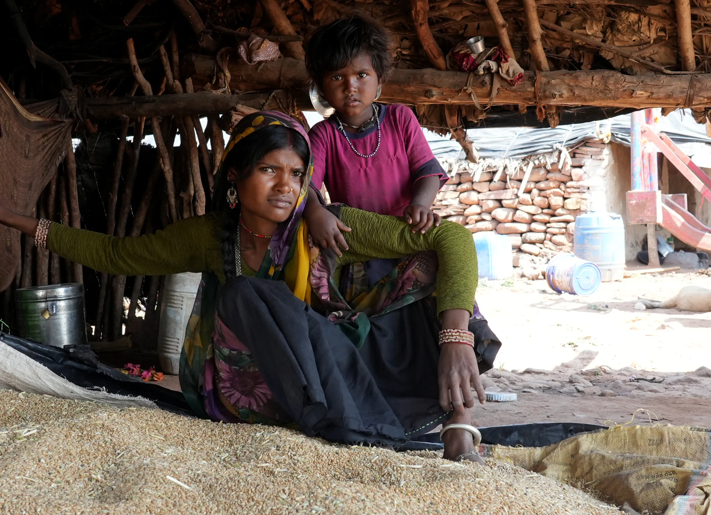 Bhimla Devi, a Mogiya tribal, and her daughter sitting inside their hut on the outskirts of Kuno National Park.