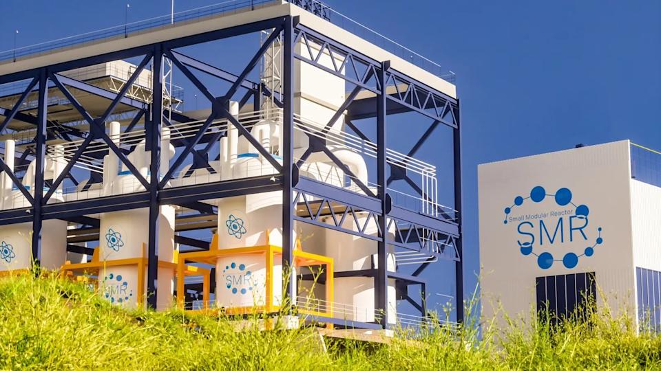 An SMR plant with a blue sky and green grass. 