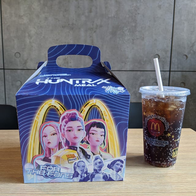 Fast food meal box and a drink on a table.