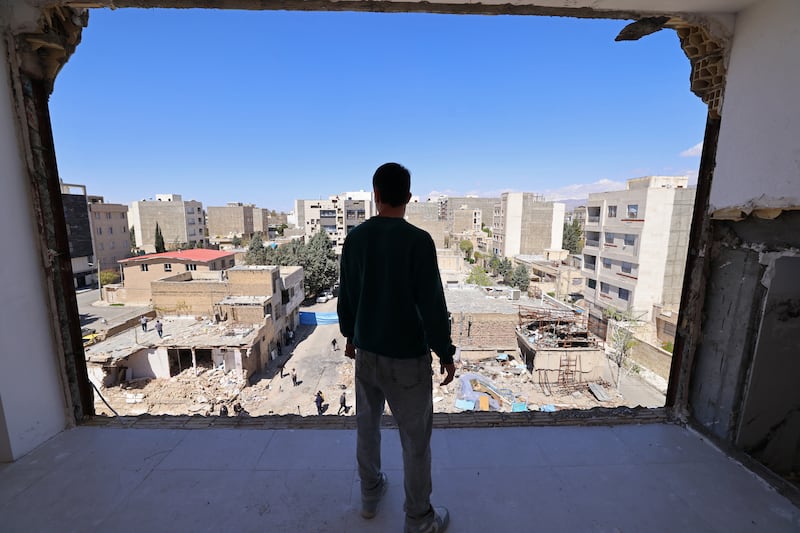 A man looks at residential buildings damaged by recent strikes at Vahdat town in Karaj, southwest of Tehran. Photograph: Atta  Kenare/Getty