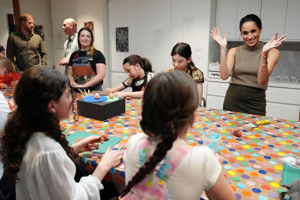 Britain's Prince Harry and Meghan, the Duke and Duchess of Sussex, take part in a model-making activity with veterans and their families at the Australian National Veterans Arts Museum (ANVAM) in Southbank, Melbourne, Australia, April 14, 2026. Jonathan Brady/Pool via REUTERS