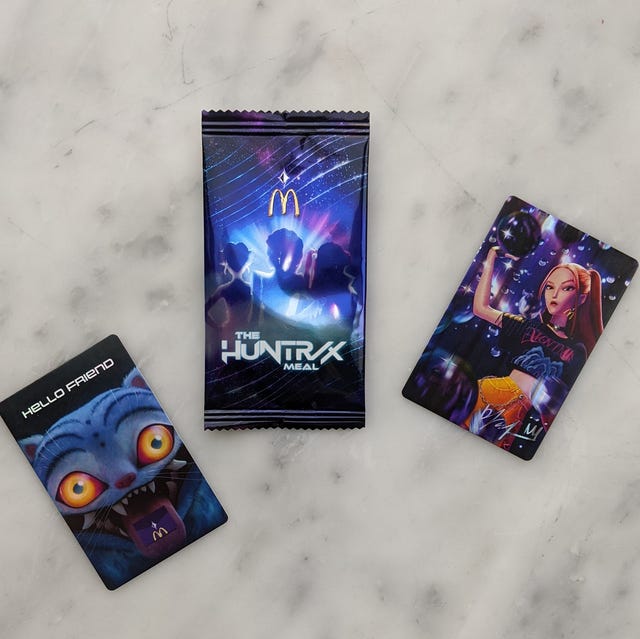 Three cards and a packaging related to a meal promotion.