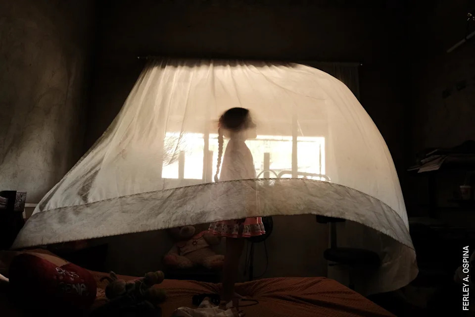 Valeria (5) plays behind a curtain at her aunt’s house. She is raised solely by her mother. In her region, 30% of households are headed exclusively by women