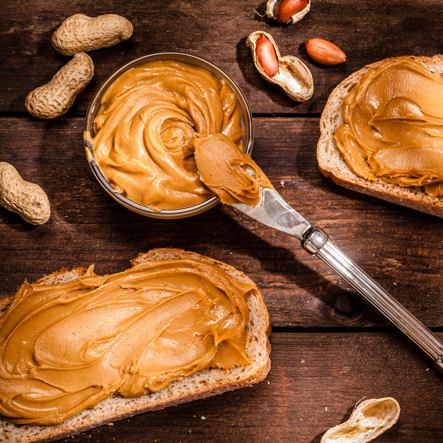 Peanut butter on toast shot on rustic wooden table