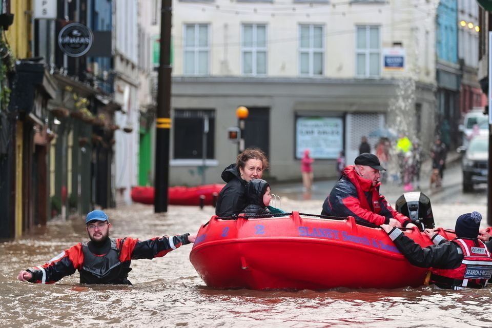 Tricia and Jude Delaney (4) in Enniscorthy town centre after the River Slaney burst its banks. Photo: Gerry Mooney.