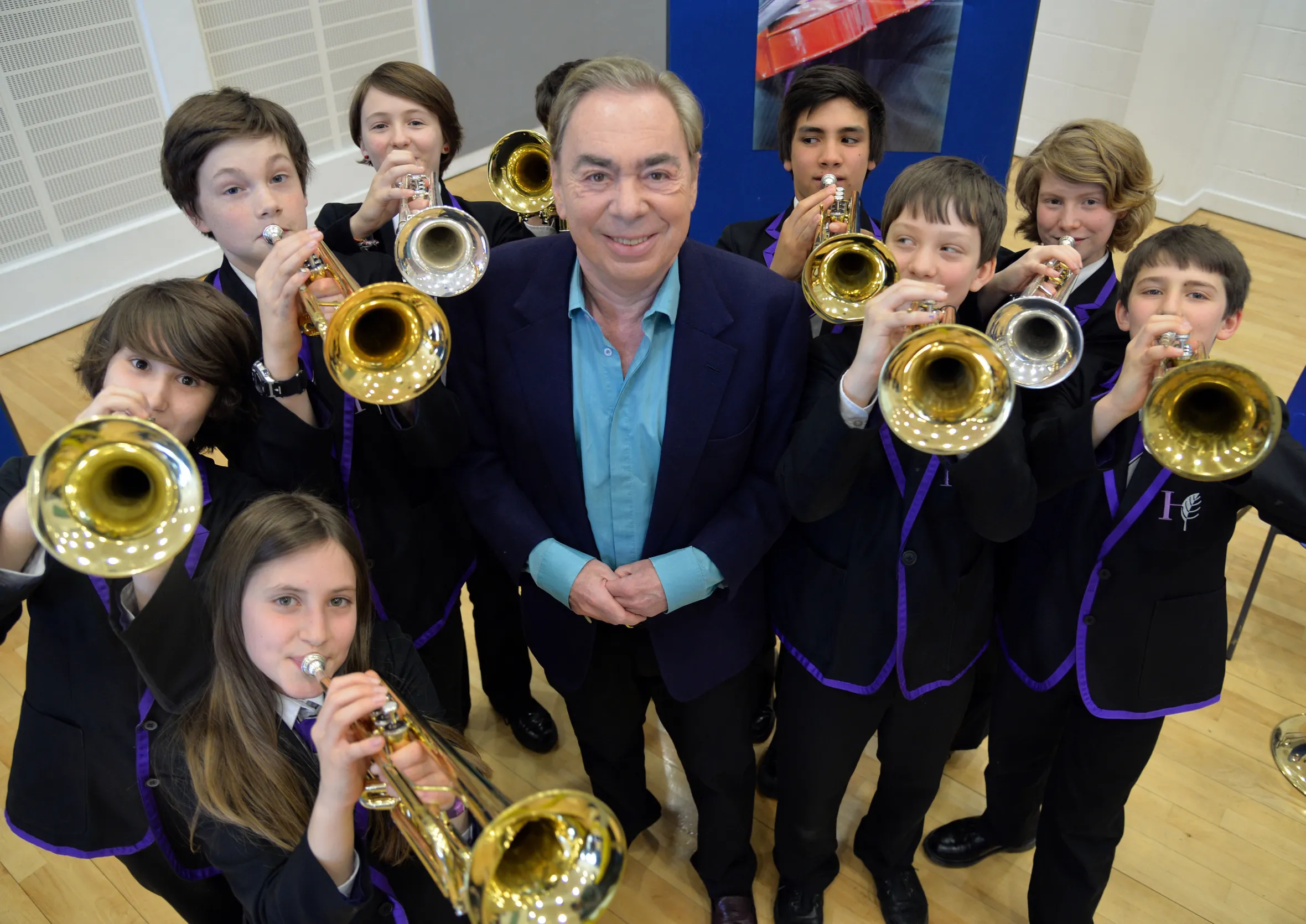 Lord Andrew Lloyd Webber surrounded by the HGS Brass Ensemble.