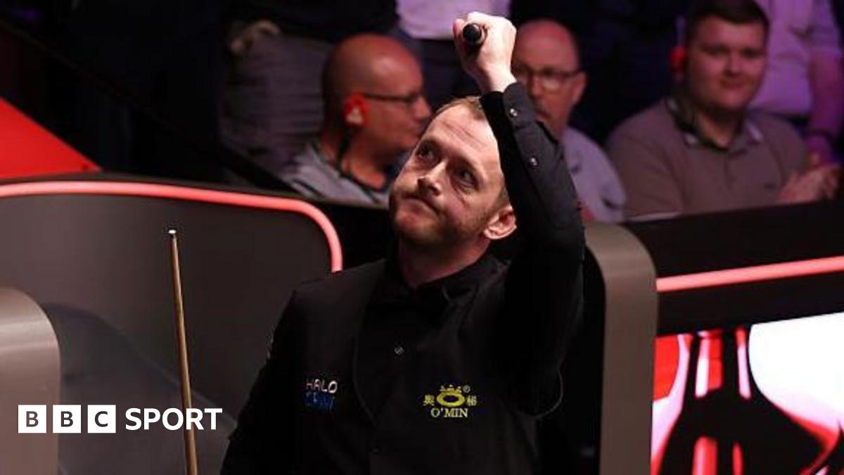 Mark Allen celebrates with his left arm raised