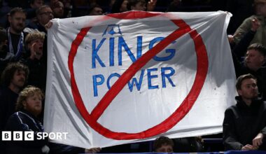 A sign is held by some Leicester City fans in protest of the club's ownership