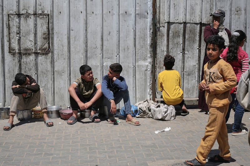 Displaced Palestinian children wait to receive food from a charity kitchen at the Nuseirat refugee camp in the central Gaza Strip on Wednesday. Photograph: Eyad Baba/AFP via Getty