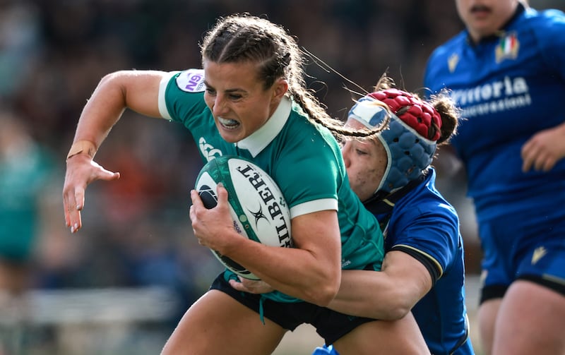 Ireland's Emily Lane is tackled by Italy's Elisa Giordano. Photograph: Dan Sheridan/Inpho