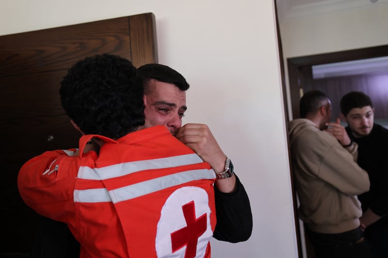 Colleagues of Hassan Ali Badawi, a paramedic with the Lebanese Red Cross who was killed on Sunday in an Israeli airstrike, mourn as the family receives condolences at their home in Zaldeh, south of Beirut, on Monday. Photograph: Anwar Amro/AFP via Getty Images