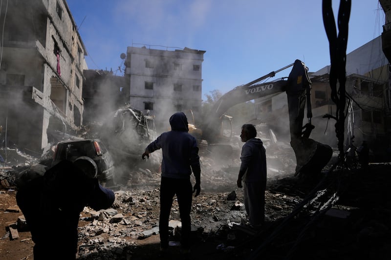 People gather on Tuesday as an excavator clears rubble at the site of Sunday’s Israeli strike on a building in Beirut’s Jnah neighbourhood, Lebanon. Photograph: Hassan Ammar/AP