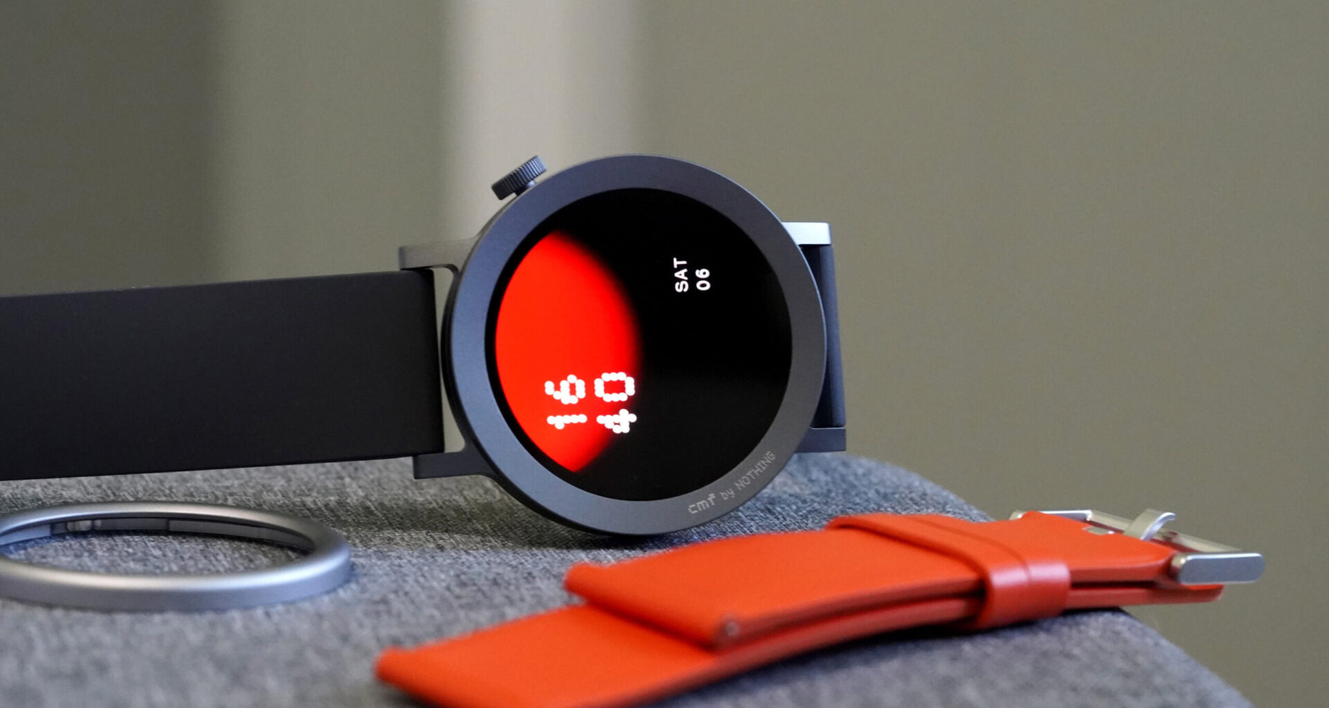 A CMF Watch Pro 2 by Nothing rests on its side, displaying a native watch face.