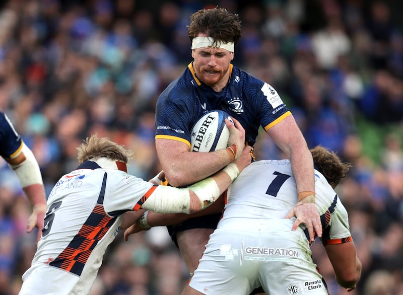 Ryan Baird of Leinster pushes past the tackles of two Edinburgh players during Sunday's Champions Cup round of 16 at the Aviva Stadium. Photograph: Bryan Keane/Inpho