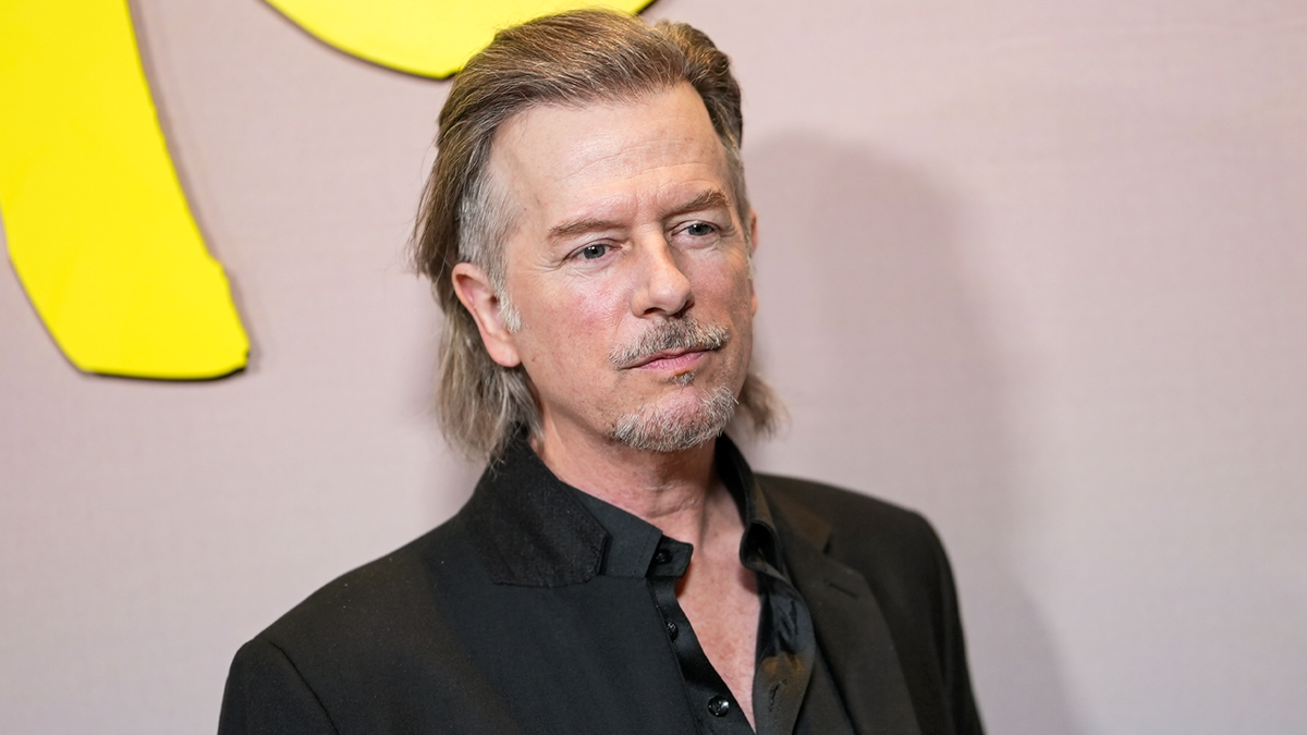 David spade poses for photo
