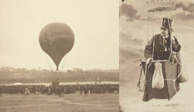 A vintage photo shows a hot air balloon lifting off before a large crowd. Beside it, a man in a suit and top hat sits in a balloon basket, holding sandbags, against a cloudy sky.