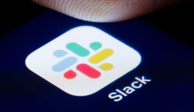 The logo of Instant Messaging Service Slack is shown on the display of a smartphone.