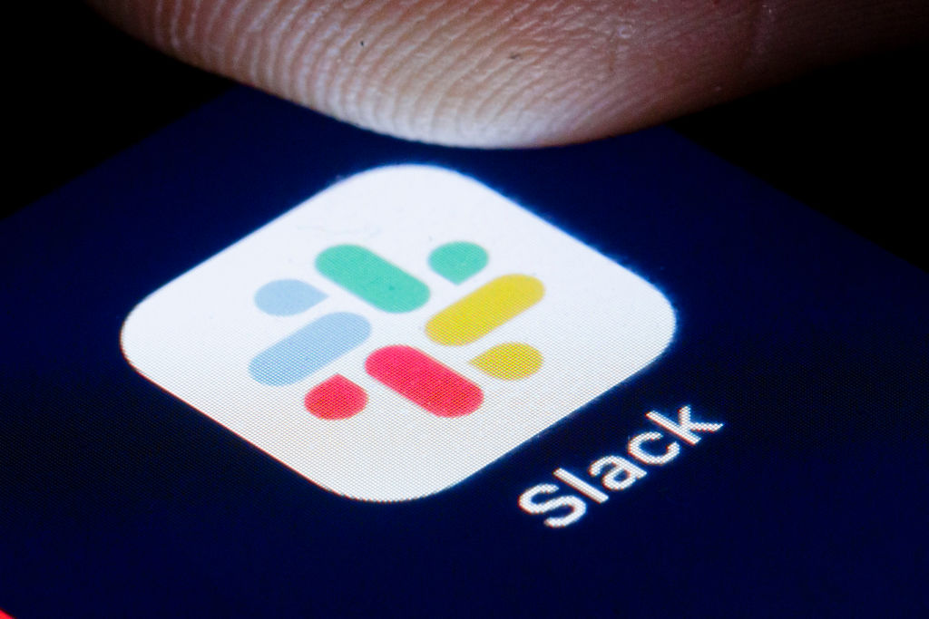 The logo of Instant Messaging Service Slack is shown on the display of a smartphone.