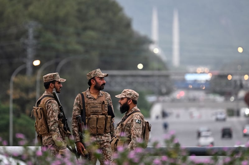 Pakistan's army soldiers stand guard on a street leading to the Red Zone area after tightened security measures ahead of the expected US-Iran peace talks in Islamabad. Photograph: Farooq Naeem / AFP via Getty Images