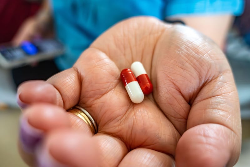 This is a generic photo of a woman holding painkillers. See PA Feature HEALTH Stroke. WARNING: This picture must only be used to accompany PA feature HEALTH Stroke. PA Photo. Picture credit should read: Alamy/PA. NOTE TO EDITORS: This picture must only be used to accompany HEALTH Stroke.