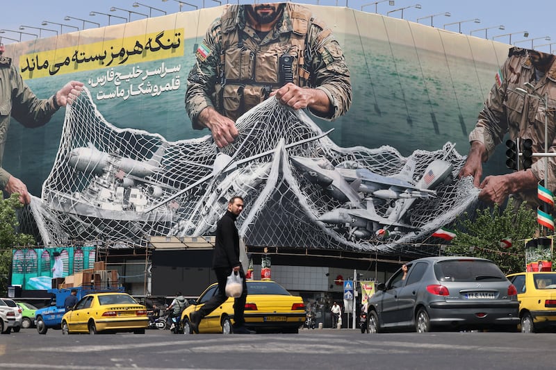 Vehicles drive past a giant billboard reading 'The Strait of Hormuz remains closed' at Revolution Square in Tehran on Tuesday. Photograph: Atta Kenare/AFP via Getty