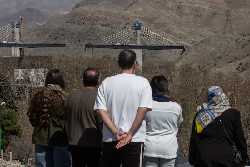 People look at the bridge in Karaj, near Tehran, damaged by US-Israeli air strikes. Photograph: Arash Khamooshi/The New York Times
                      