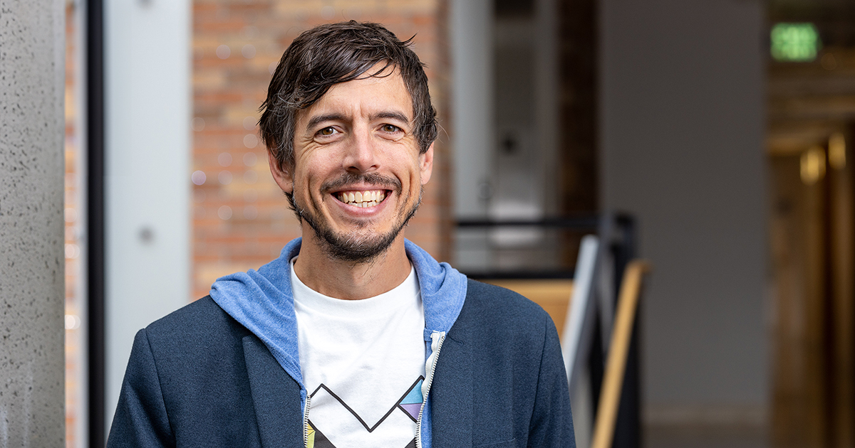 Portrait of Jon Froehlich wearing a shirt with the Makeability Lab logo.
