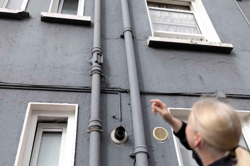 Lynsey McGrath, who lives in the Mercer House flat complex in Dublin, is experiencing mould and sewage leaking from an exterior drain pipe. Photograph: Chris Maddaloni