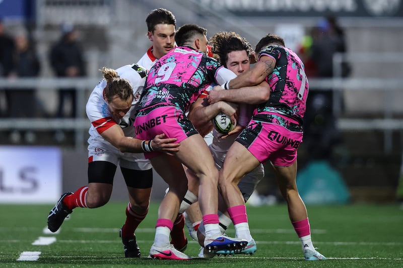 Ulster's Dave McCann is tackled by Reuben Morgan-Williams and Luke Morgan of Ospreys. Photograph: Ben Brady/Inpho