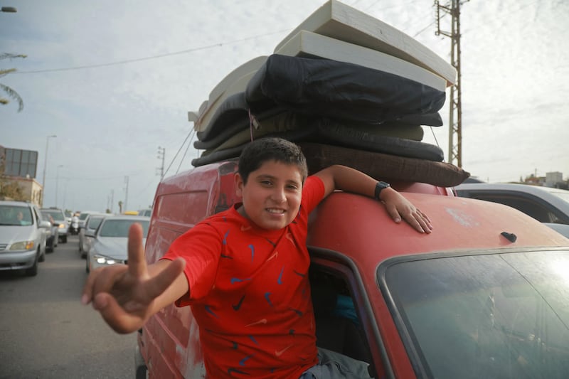 A boy who was displaced travels through the Qasmieh area on the way back to his home in southern Lebanon on Friday. Photo by Ibrahim Amro/AFP via Getty Images