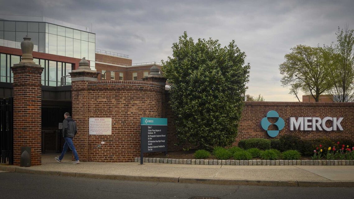 Photo of the entrance and brick wall around Merck's headquarters building in New Jersey, bearing the Merck logo.